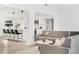 Inviting living space with modern sofas, a stylish coffee table, and an open view to the kitchen with bar seating at 3856 Monica Pkwy, Sarasota, FL 34235