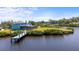 Waterfront property with private dock, screened-in lanai, and expansive backyard with mature trees and lush lawn at 408 Inlet Rd, Ruskin, FL 33570