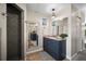 Bathroom featuring tile floor, granite countertop, shower, and blue vanity at 408 Inlet Rd, Ruskin, FL 33570