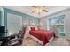 Comfortable bedroom with plentiful natural light, shuttered windows, and white wicker furniture at 4131 Salernes Ave # 3051, Sarasota, FL 34233