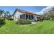 Well-maintained home featuring a tile roof, screened-in lanai, and lush landscaping at 4131 Salernes Ave # 3051, Sarasota, FL 34233