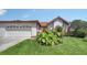 Charming home showcasing a well-maintained lawn and lush landscaping, offering a welcoming appeal at 4131 Salernes Ave # 3051, Sarasota, FL 34233