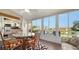Enclosed lanai with glass table and views of the pond and surrounding community at 4131 Salernes Ave # 3051, Sarasota, FL 34233
