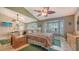 Cozy main bedroom featuring a bay window, fan, and mirrored wall at 4131 Salernes Ave # 3051, Sarasota, FL 34233