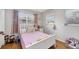 Bright and cheerful bedroom with a pink bedspread, white furniture, and plenty of natural light at 4243 Maceachen Blvd, Sarasota, FL 34233