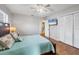 Comfortable bedroom with wood-look flooring, light blue bedding, and a mounted TV above the bed at 4243 Maceachen Blvd, Sarasota, FL 34233