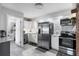 Modern kitchen with stainless steel appliances, white cabinets, and stylish backsplash at 4243 Maceachen Blvd, Sarasota, FL 34233