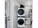 Functional laundry area equipped with stacked washer and dryer units and a utility sink at 4243 Maceachen Blvd, Sarasota, FL 34233