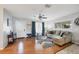 Bright living room with hardwood floors, a ceiling fan, and a comfortable seating area at 4243 Maceachen Blvd, Sarasota, FL 34233