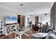 Comfortable living room with a cozy sofa, wood-look flooring, and a TV mounted on a stylish entertainment center at 4243 Maceachen Blvd, Sarasota, FL 34233