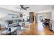 Open concept living room with hardwood floors, brick accent wall, and views of the kitchen and dining area at 4243 Maceachen Blvd, Sarasota, FL 34233