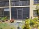 Exterior of the home featuring enclosed lanai and plants in the backyard at 425 30Th W Ave # C104, Bradenton, FL 34205