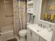 Bathroom vanity with storage cabinets, shower with a curtain, toilet at 425 30Th W Ave # C104, Bradenton, FL 34205
