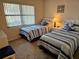 Bedroom featuring two beds with matching decor at 425 30Th W Ave # C104, Bradenton, FL 34205