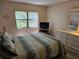 Comfortable bedroom with queen bed and view of backyard from bedroom window at 425 30Th W Ave # C104, Bradenton, FL 34205