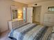 Serene bedroom with neutral colors and a comfortable bed, a vanity and convenient access to the kitchen at 425 30Th W Ave # C104, Bradenton, FL 34205