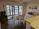 Cozy dining area features a round table, seating for four, and sliding glass doors to a lanai at 425 30Th W Ave # C104, Bradenton, FL 34205