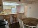 Open dining area with bar seating and a round table, perfect for casual meals and entertaining at 425 30Th W Ave # C104, Bradenton, FL 34205
