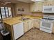 Functional kitchen features ample counter space, white appliances, and a convenient breakfast bar at 425 30Th W Ave # C104, Bradenton, FL 34205