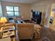Inviting living room featuring a comfortable seating arrangement and view to the bedroom at 425 30Th W Ave # C104, Bradenton, FL 34205