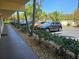Well-maintained parking area shows a row of cars parked in front of a condo building at 425 30Th W Ave # C104, Bradenton, FL 34205