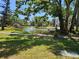 Beautiful pond view features a gazebo, fountain, and landscaping, with a condo building in the background at 425 30Th W Ave # C104, Bradenton, FL 34205