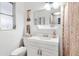 Bright bathroom features a white vanity, large mirror, toilet, and a patterned shower curtain at 432 Crosby Ct, Sarasota, FL 34237