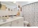 Functional bathroom featuring a white vanity, mirror, toilet, and a shower with a decorative curtain at 432 Crosby Ct, Sarasota, FL 34237