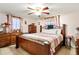 Traditional bedroom showcasing wooden furniture, patterned bedding, tile floors, and decorative accents at 432 Crosby Ct, Sarasota, FL 34237