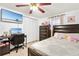 Neutral bedroom features a wooden bed, closet, desk, television, tile floors, and a ceiling fan at 432 Crosby Ct, Sarasota, FL 34237