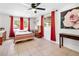 Bright bedroom features large windows, red drapes, tiled floors, and a decorative rose painting at 432 Crosby Ct, Sarasota, FL 34237