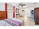 Spacious bedroom with tile flooring, large windows, a painting, and an en-suite bathroom at 432 Crosby Ct, Sarasota, FL 34237