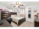 Cozy bedroom featuring neutral decor, tile floors, a ceiling fan, and a dark wooden bed frame at 432 Crosby Ct, Sarasota, FL 34237