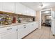 Bright kitchen features white cabinets, granite countertops, stainless steel appliances, and tile flooring at 432 Crosby Ct, Sarasota, FL 34237