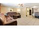 Cozy living room featuring tile floors, comfortable sofas, and an open layout leading to the dining area at 432 Crosby Ct, Sarasota, FL 34237