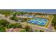 An aerial view showcasing multiple tennis courts next to the Gulf of Mexico and nearby condominiums at 4510 El Conquistador Pkwy # 105, Bradenton, FL 34210