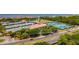 Aerial shot showcasing the complex's amenities, including tennis courts, surrounded by lush greenery at 4510 El Conquistador Pkwy # 105, Bradenton, FL 34210