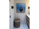 Close-up of bathroom details including a painting, wall decor, and a stylish vanity with a white sink at 4510 El Conquistador Pkwy # 105, Bradenton, FL 34210