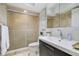 Bathroom featuring a shower with glass doors, a modern vanity, and neutral tones for a clean and inviting space at 4510 El Conquistador Pkwy # 105, Bradenton, FL 34210