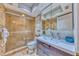 Inviting bathroom featuring a shower with glass doors, a modern vanity, and decor, creating a clean and stylish space at 4510 El Conquistador Pkwy # 105, Bradenton, FL 34210