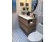 Modern bathroom features updated toilet, stylish vanity, and decorative tile floor at 4510 El Conquistador Pkwy # 105, Bradenton, FL 34210