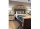A bedroom featuring a queen bed, blue throw, end tables with lamps and artwork on the wall at 4510 El Conquistador Pkwy # 105, Bradenton, FL 34210