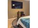 Cozy bedroom features a wall-mounted television and colorful rug at 4510 El Conquistador Pkwy # 105, Bradenton, FL 34210
