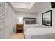 Cozy bedroom featuring a closet, a nightstand with a lamp, and a comfortable bed with decorative pillows at 4510 El Conquistador Pkwy # 105, Bradenton, FL 34210