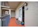 Charming unit entrance with potted plants and an inviting doormat, with convenient access to main hallway at 4510 El Conquistador Pkwy # 105, Bradenton, FL 34210