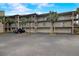 Condos feature garages and balconies surrounded by tropical landscaping and palm trees for relaxed living at 4510 El Conquistador Pkwy # 105, Bradenton, FL 34210