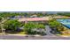 Beautiful view of Cartagena Condominiums with manicured landscaping, a private parking area and a peek of the blue ocean at 4510 El Conquistador Pkwy # 105, Bradenton, FL 34210