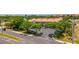 Exterior shot of the Cartagena Condominiums featuring lush landscaping, mature trees, and convenient private parking at 4510 El Conquistador Pkwy # 105, Bradenton, FL 34210