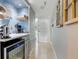 Charming hallway area with a beverage refrigerator, a decorated wall niche, and an inviting entrance doorway at 4510 El Conquistador Pkwy # 105, Bradenton, FL 34210