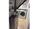 Small, functional laundry room with a side-by-side washer and dryer and charming decor at 4510 El Conquistador Pkwy # 105, Bradenton, FL 34210